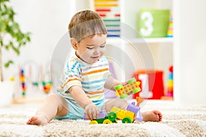 Kid playing with building blocks at kindergarten