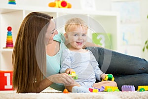 Kid playing with building blocks at kindergarten