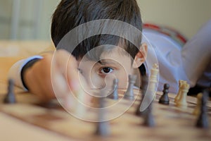 Kid playing chess in his house