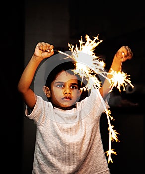 Kid playing with fire crackers on Diwali Festival