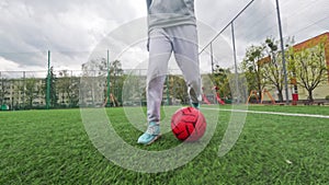 Kid Playing Football, Training With Ball On A Football Field