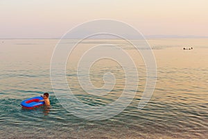 Kid playing with inflatable boat