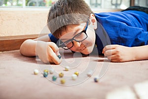 Kid playing with marbles photo