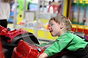 Kid playing with motorcycle simulator