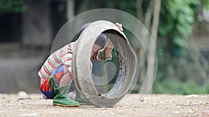 Kid playing with old tire in Sa Pa Valley photo