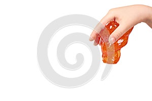 kid playing orange slime with hand, transparent toy