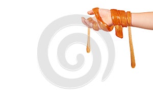 kid playing orange slime with hand, transparent toy