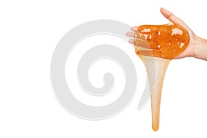 kid playing orange slime with hand, transparent toy