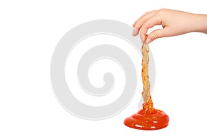 kid playing orange slime with hand, transparent toy