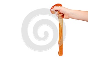 kid playing orange slime with hand, transparent toy