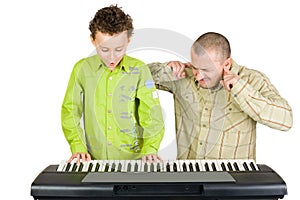 Kid playing piano badly