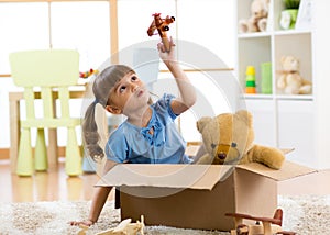 Kid playing with plane toy at home. Travel, freedom and imagination concept.
