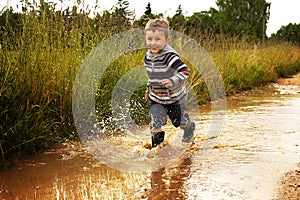 Kid playing in puddle