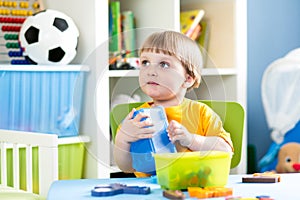 Kid playing with puzzle toy indoor