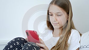 Kid Playing Smartphone at Home, Teenager Child Browsing Internet in Bedroom, Girl in Bed use Touchscreen Smart Phone