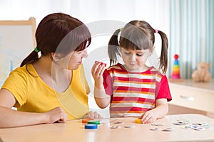 Kid playing with speech therapist photo