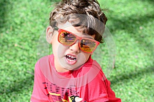 Kid playing with sunglasses