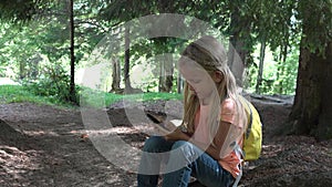 Kid Playing Tablet on Meadow in Camping in Mountains, Child Use Smartphones in Forest, Girl Plays on Device Outdoor in Park