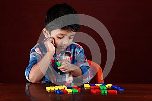 A kid playing with toy alphabets