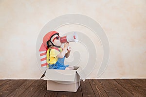 Kid playing with toy rocket at home