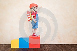 Kid playing with toy rocket at home