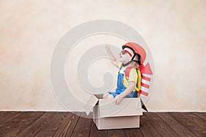 Kid playing with toy rocket at home