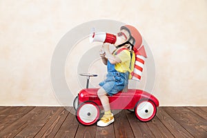 Kid playing with toy rocket at home