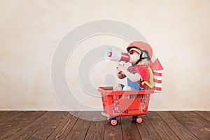 Kid playing with toy rocket at home