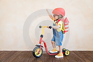 Kid playing with toy rocket at home