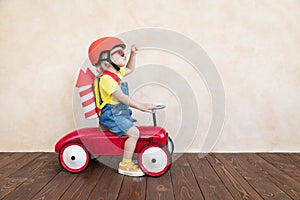 Kid playing with toy rocket at home