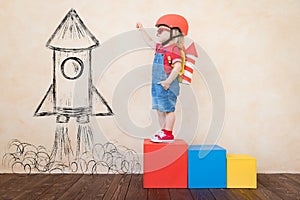 Kid playing with toy rocket at home