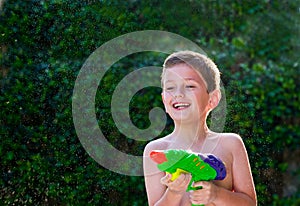 Kid playing with water toy.