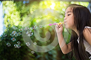 Kid pLAYLING BLowing Bubbles Together at the Field