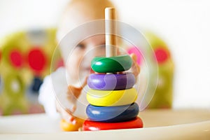 The kid plays the pyramid. child playing with toys