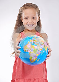 Kid, portrait and globe in studio with world, planets and city for education, geography and happy. Student, girl child