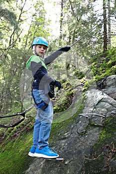 Kid posing with climbing equipment in park