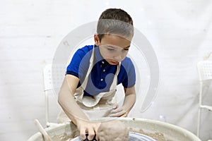 Kid at pottery wheel