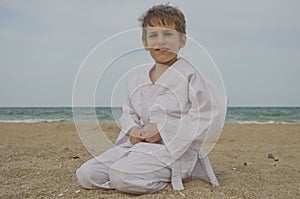 Kid practicing Aikido on the beach