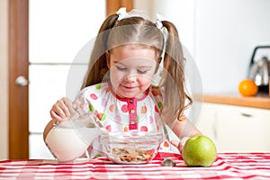 Kid preparing corn flakes with milk