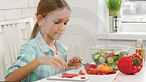 Kid preparing green salad in kitchen, child cutting vegetables girl healthy food