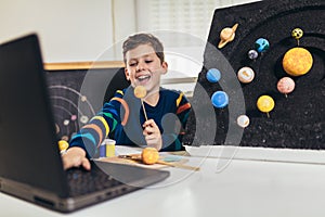 Kid presenting his science home project