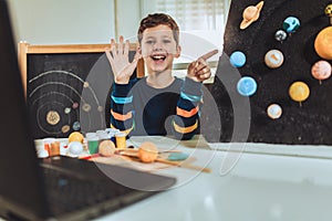 Kid presenting his science home project - the planets of our solar system.