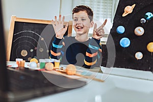 Kid presenting his science home project - the planets of our solar system.