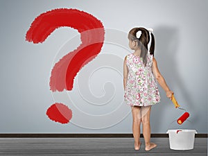 Kid question concept. Child girl draws question mark on wall