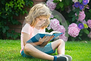 Kid read book. Child school and outdoor education. Nature and park. Early learning. Summer outdoor. Learning concept.