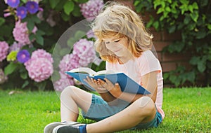 Kid read book. Child school and outdoor education. Nature and park. Early learning. Summer outdoor. Learning concept.