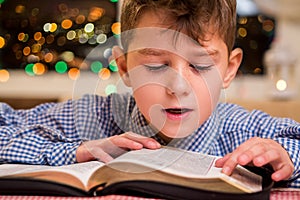 Kid reading book out loud.