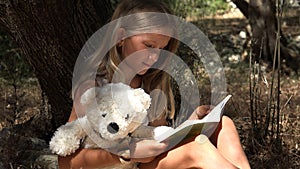 Kid Reading Book by Tree in Park, Schoolgirl Enjoying Outdoor Child Studying in Nature, Teenager Girl Relaxing in Forest Education