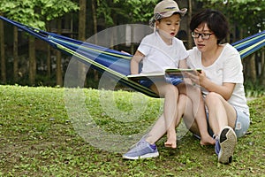 Kid reading with mom together