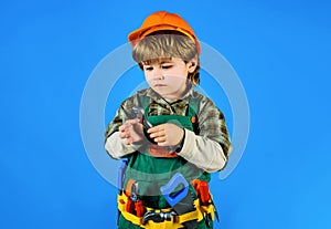 Kid repairman with toolbelt with wrench. Little kid in builder uniform with spanner. Child game. Boy construction worker